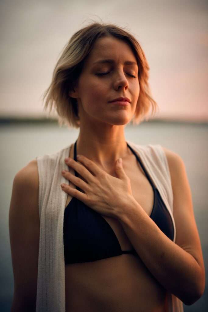 woman with hand on chest