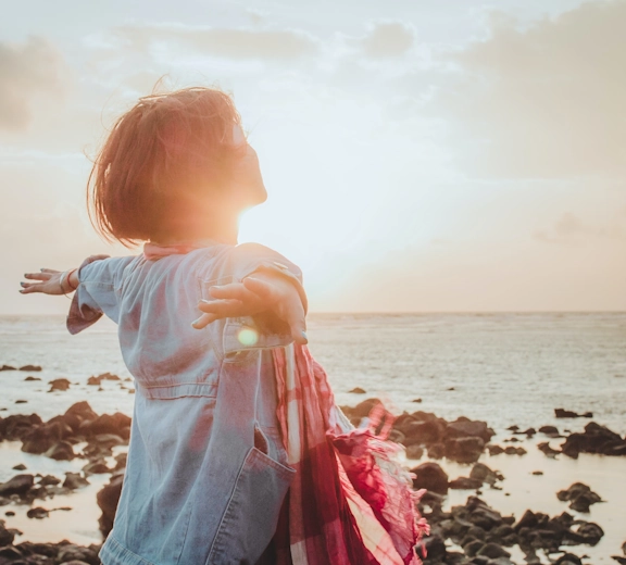 A woman enjoys the sunshine as she experiences relief from anxiety